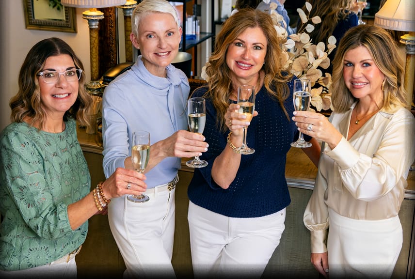 The La Bella Donna team raising a champagne toast to 20 years